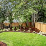 backyard with plant landscaping surrounded by a fence