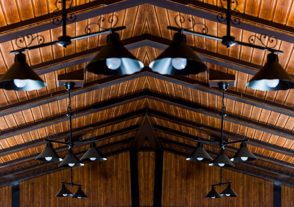 outdoor chandeliers handing from a wooden ceiling
