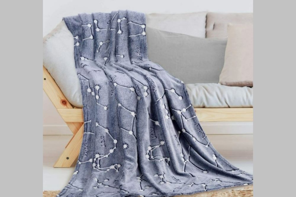 gray blanket with glow in the dark constellations
